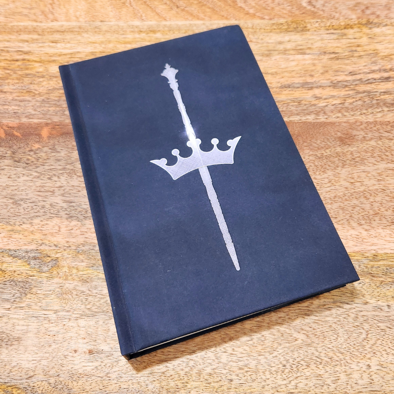 Blade of Ash hardback book cover art of a scepter and crown