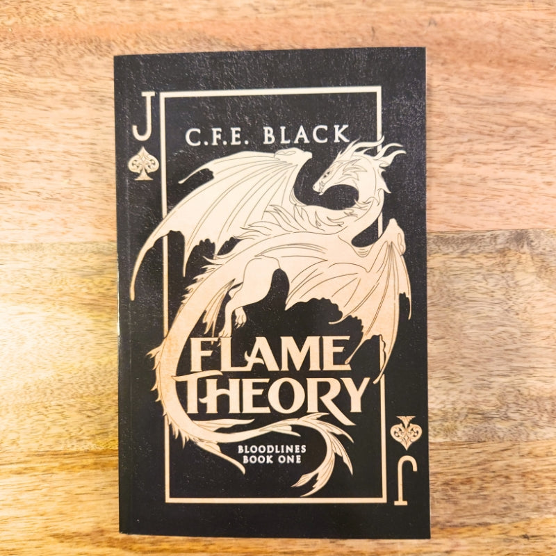 flame theory glossy paperback with black and gold cover displaying a dragon