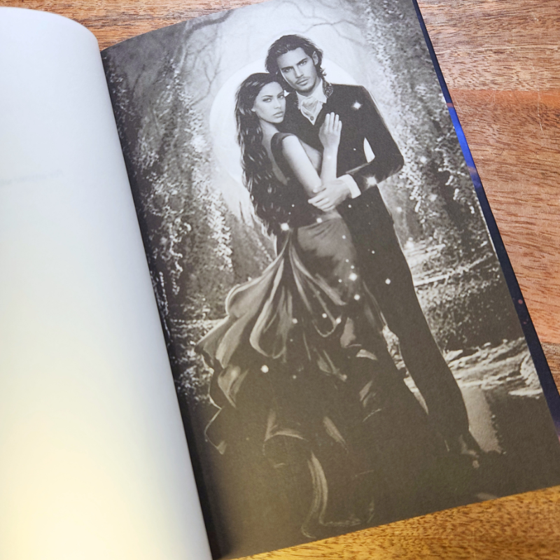 Open book with black and white character art of a couple embracing.